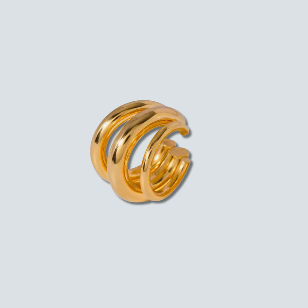 Gold spiral ring on a light gray background