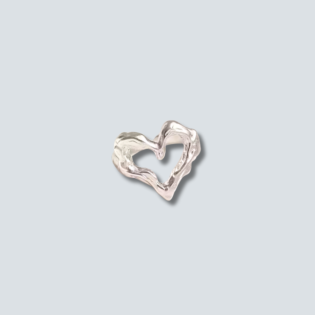 Silver heart-shaped RING on a light gray background