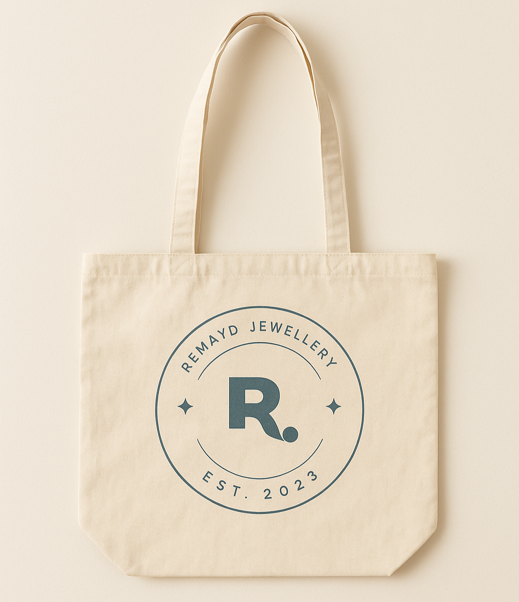 Beige tote bag with 'Remayd Jewellery' logo on a beige background