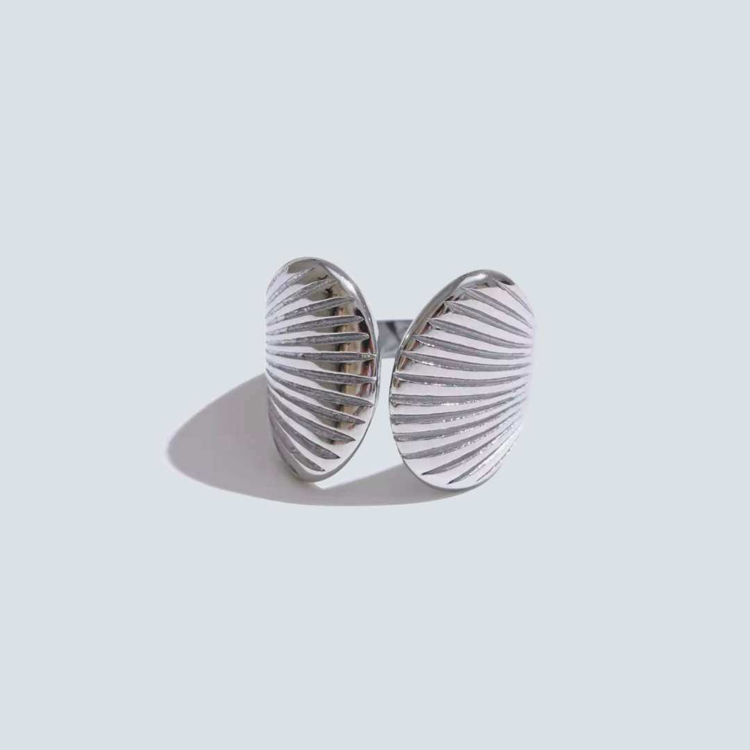 Silver ring with a textured design on a light gray background