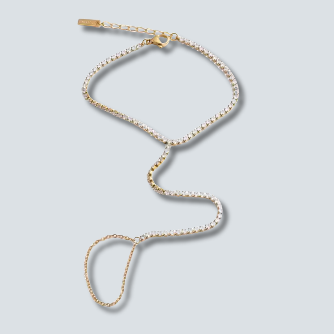 Gold and pearl necklace on a light gray background