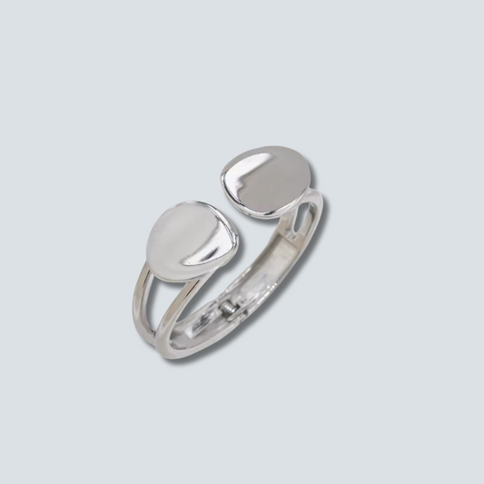 Silver ring with two rounded stones on a light gray background