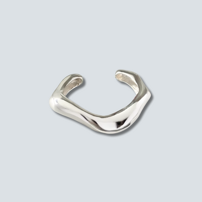 Silver ring on a light gray background