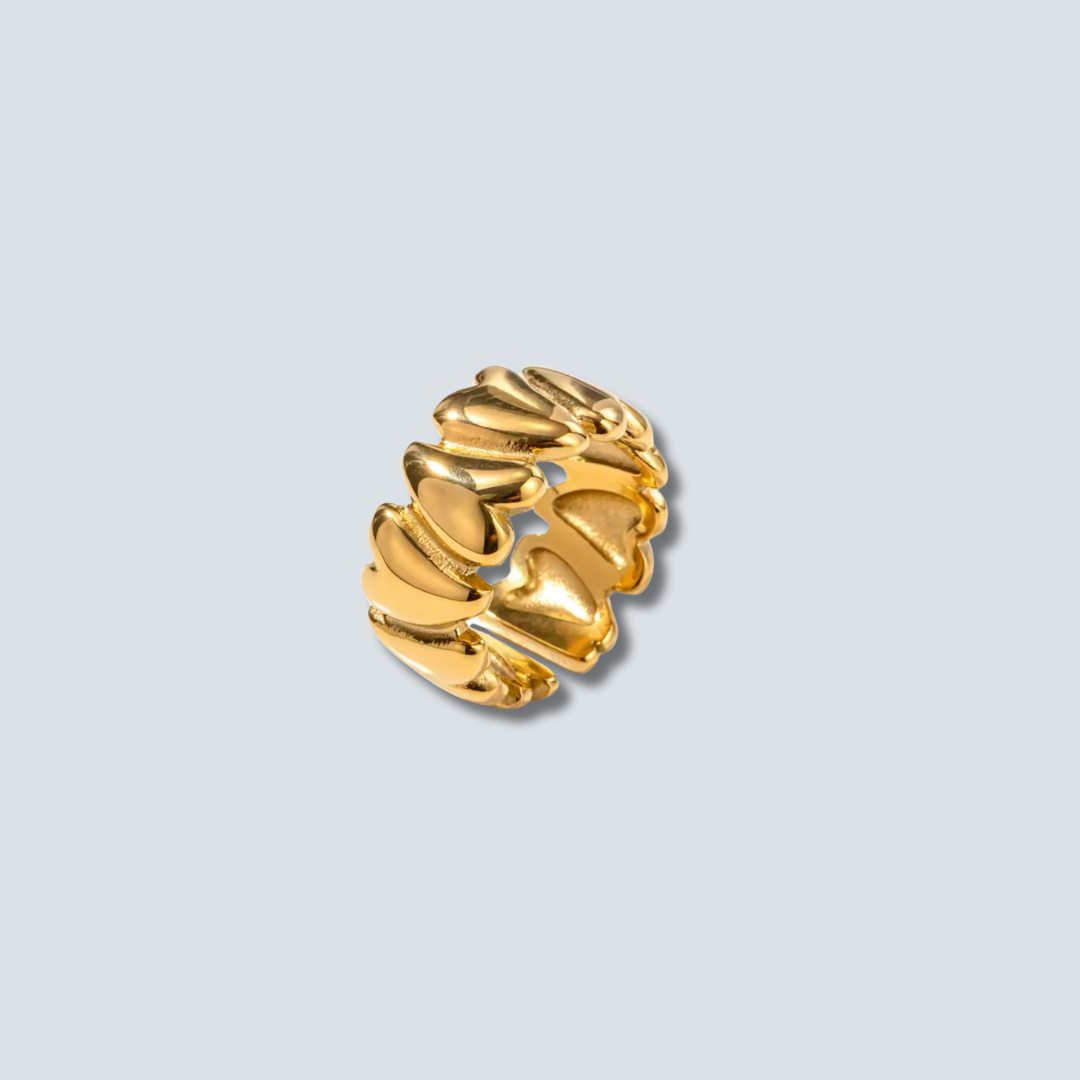 Gold earring on a light gray background