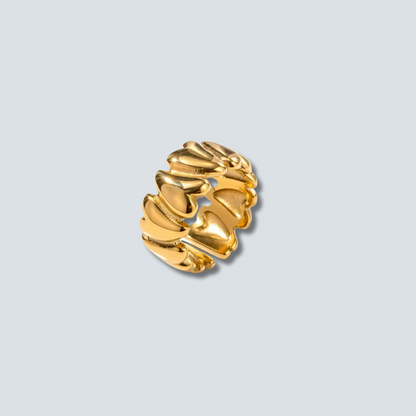 Gold earring on a light gray background
