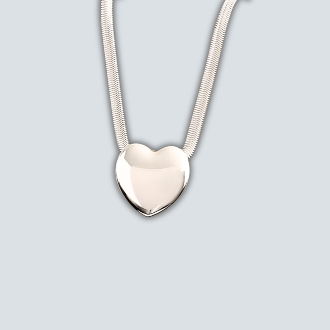 Silver heart-shaped pendant on a light gray background