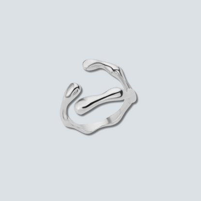 Silver ring with a modern design on a light gray background