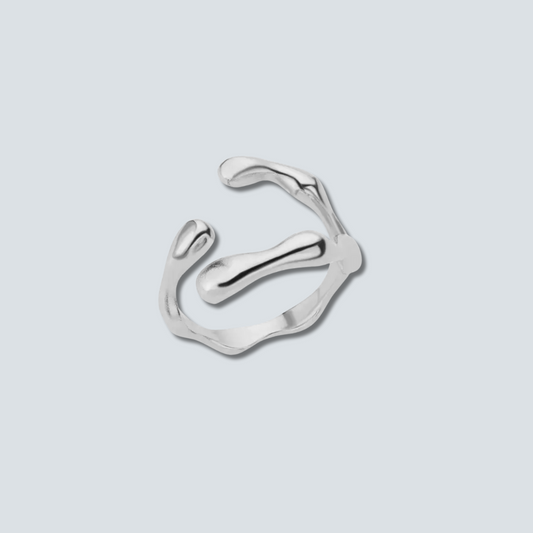Silver ring with a modern design on a light gray background