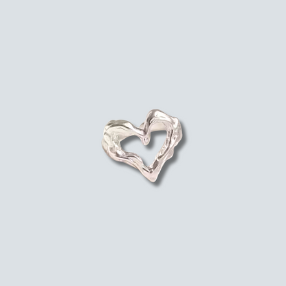 Silver heart-shaped RING on a light gray background