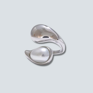 Silver cufflinks on a light gray background