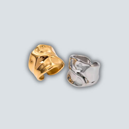Gold and silver rings on a light gray background