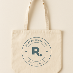 Beige tote bag with 'Remayd Jewellery' logo on a beige background