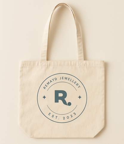 Beige tote bag with 'Remayd Jewellery' logo on a beige background
