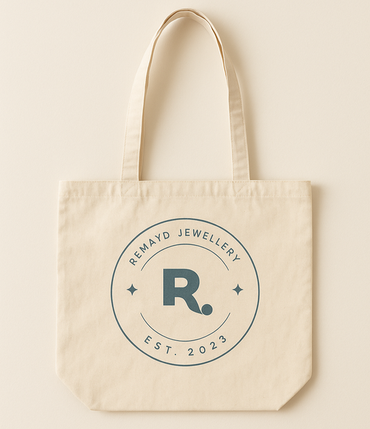 Beige tote bag with 'Remayd Jewellery' logo on a beige background