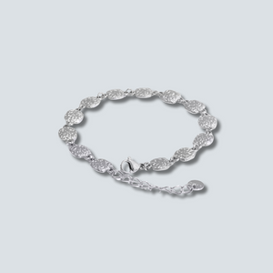 Silver bracelet on a light gray background