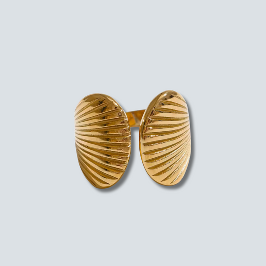 Gold shell-shaped RING on a light gray background