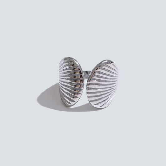 Silver ring with a textured design on a light gray background