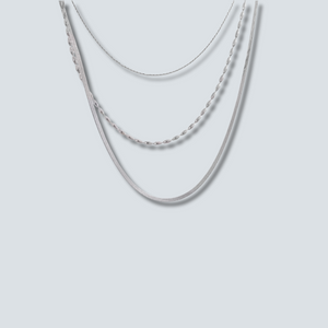 Two silver necklaces on a light gray background